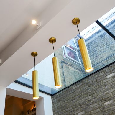 05_exposed-interior brickwork-frameless glass-roof-gold_lantern-pendant-lights